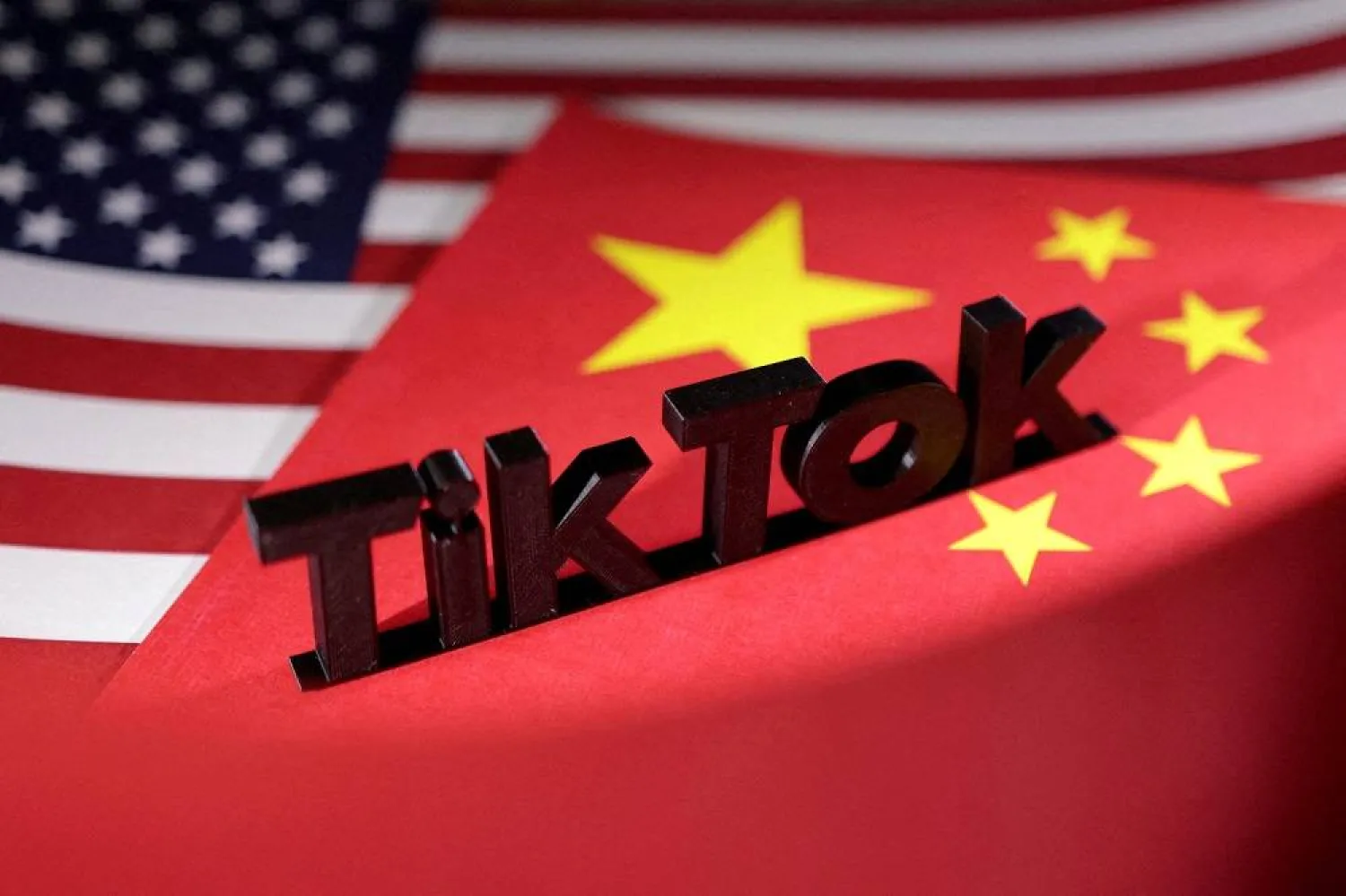 The TikTok logo is placed on the US and Chinese flags in this illustration taken, April 25, 2024. (Reuters)