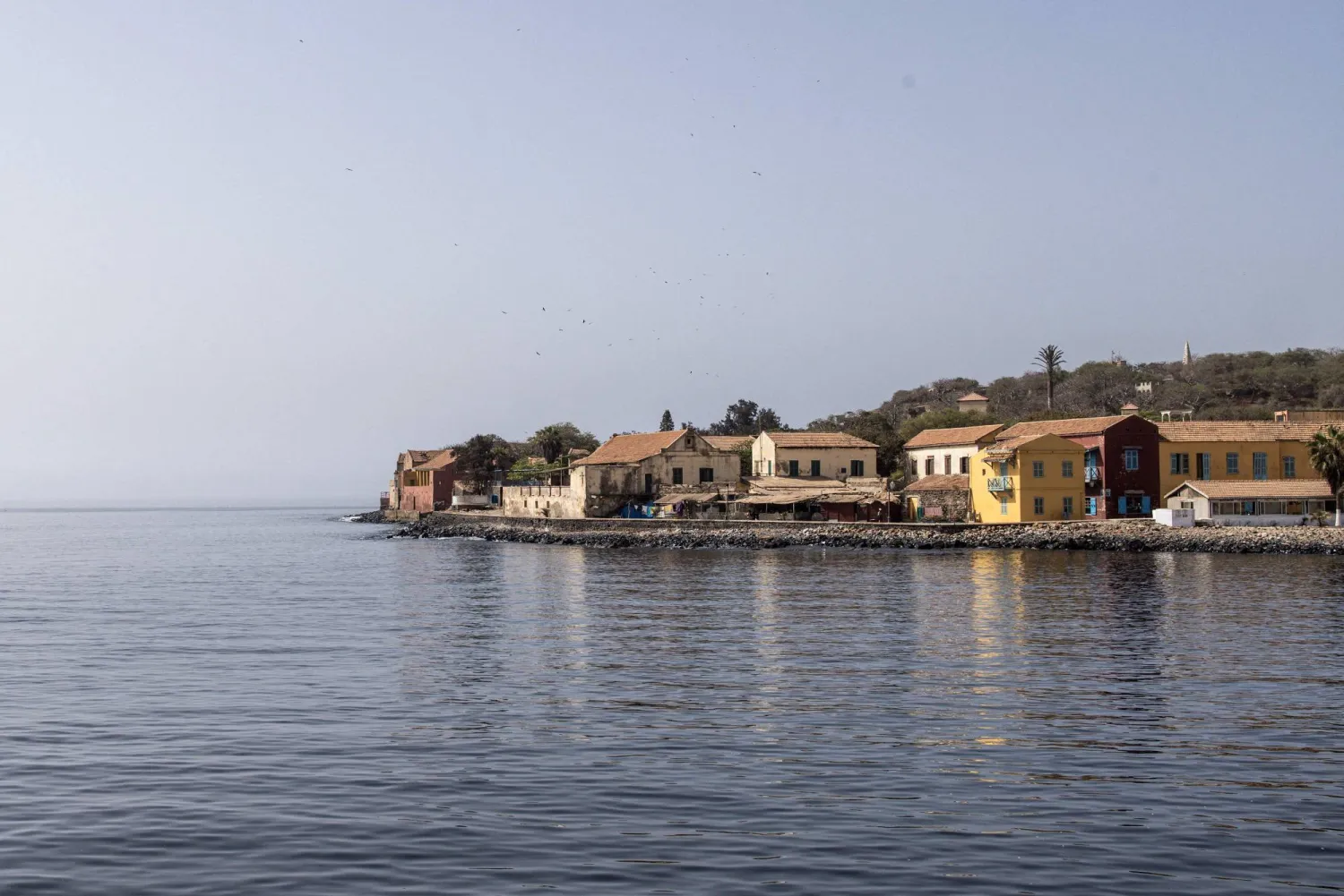 This photograph shows old colonial style houses on Goree Island in Dakar on May 8, 2024. (Photo by JOHN WESSELS / AFP)