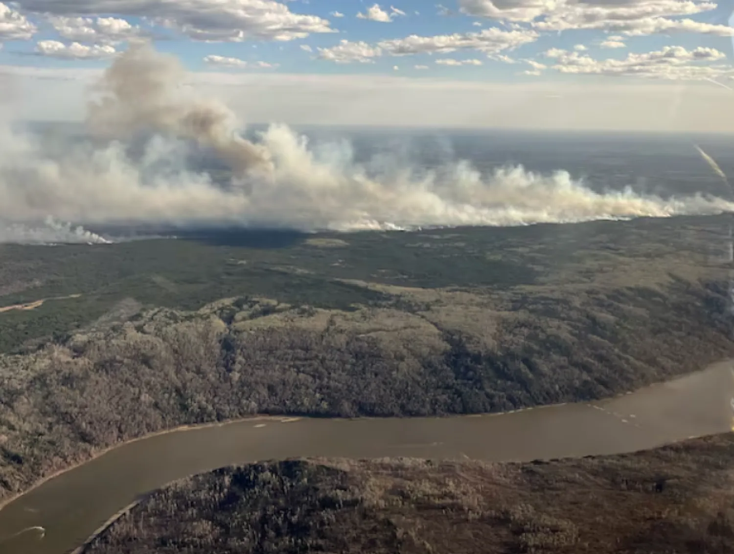 A picture taken through a window shows smoke rising from wildfire MWF017 on the south side of the Athabasca River valley near Fort McMurray, Alberta, Canada May 10, 2024. Alberta Wildfire/Handout via REUTERS/File Photo Purchase Licensing Rights