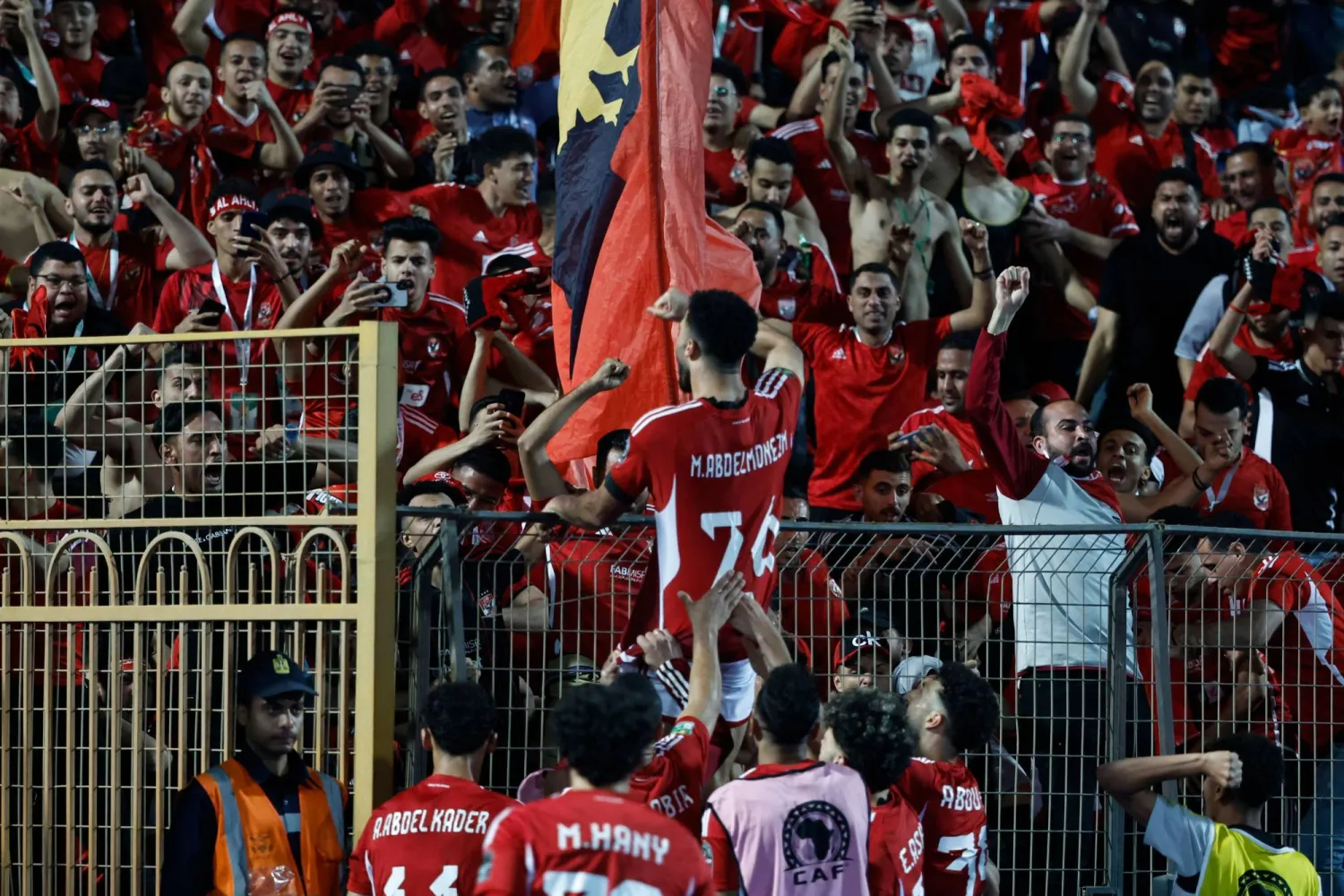 Ahly's Egyptian defender #24 Mohamed Abdelmonem celebrates with the fans after scoring his team's first goal during the second leg of the CAF Champions League football match between Egypt's Al-Ahly and Congo's TP Mazembe at at the Cairo International Stadium in Cairo on April 26, 2024. (Photo by Khaled DESOUKI / AFP)