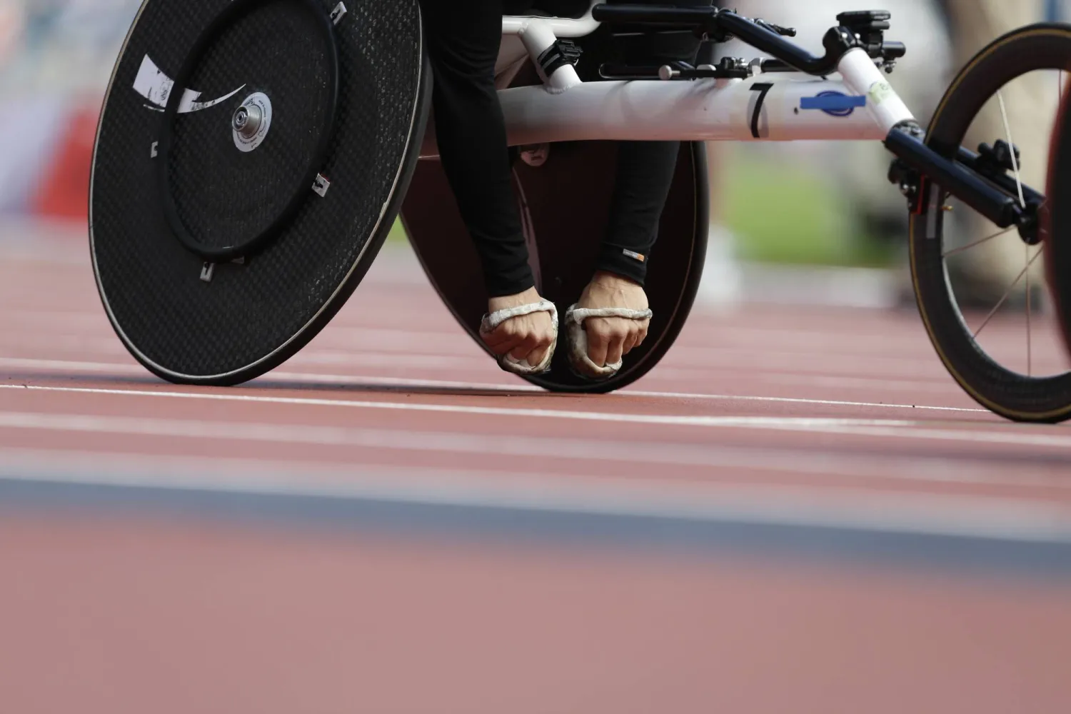 FILE - The padded hands of Diane Roy of Canada are seen as she waits to compete in the women' 800-meter T54 heat at the 2012 Paralympics games, on Sept. 4, 2012, in London. (AP Photo/Alastair Grant)
