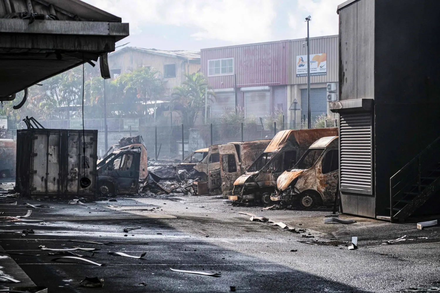 A burnt vehicle is seen in the Normandy industrial zone in Noumea, France's Pacific territory of New Caledonia, on May 20, 2024. (Photo by Theo Rouby / AFP)
