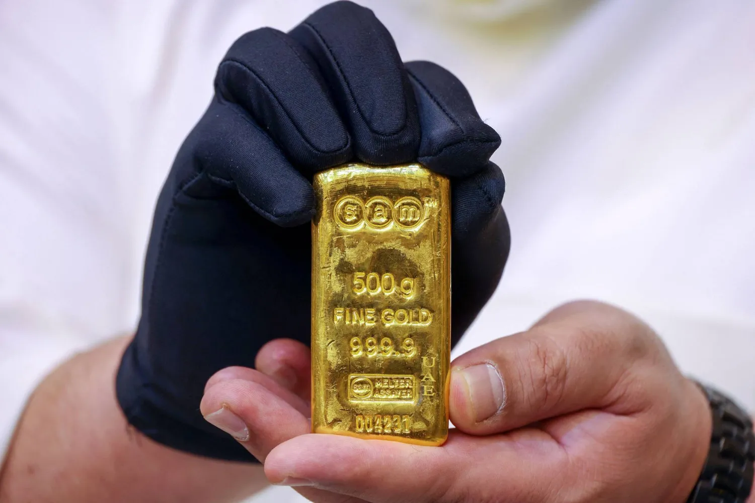 A jeweller shows a gold bar at his shop in downtown Kuwait City on May 20, 2024. (Photo by YASSER AL-ZAYYAT / AFP)