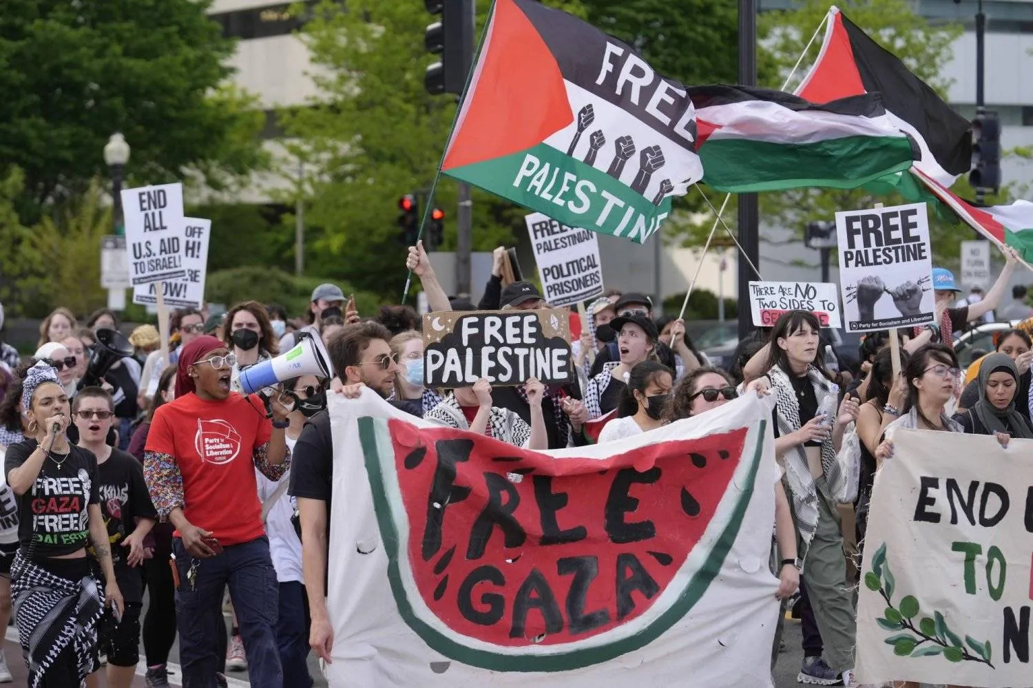 Demonstrators display Palestinian flags and chant slogans while marching Tuesday, May 21, 2024, in Boston. (AP Photo/Steven Senne)