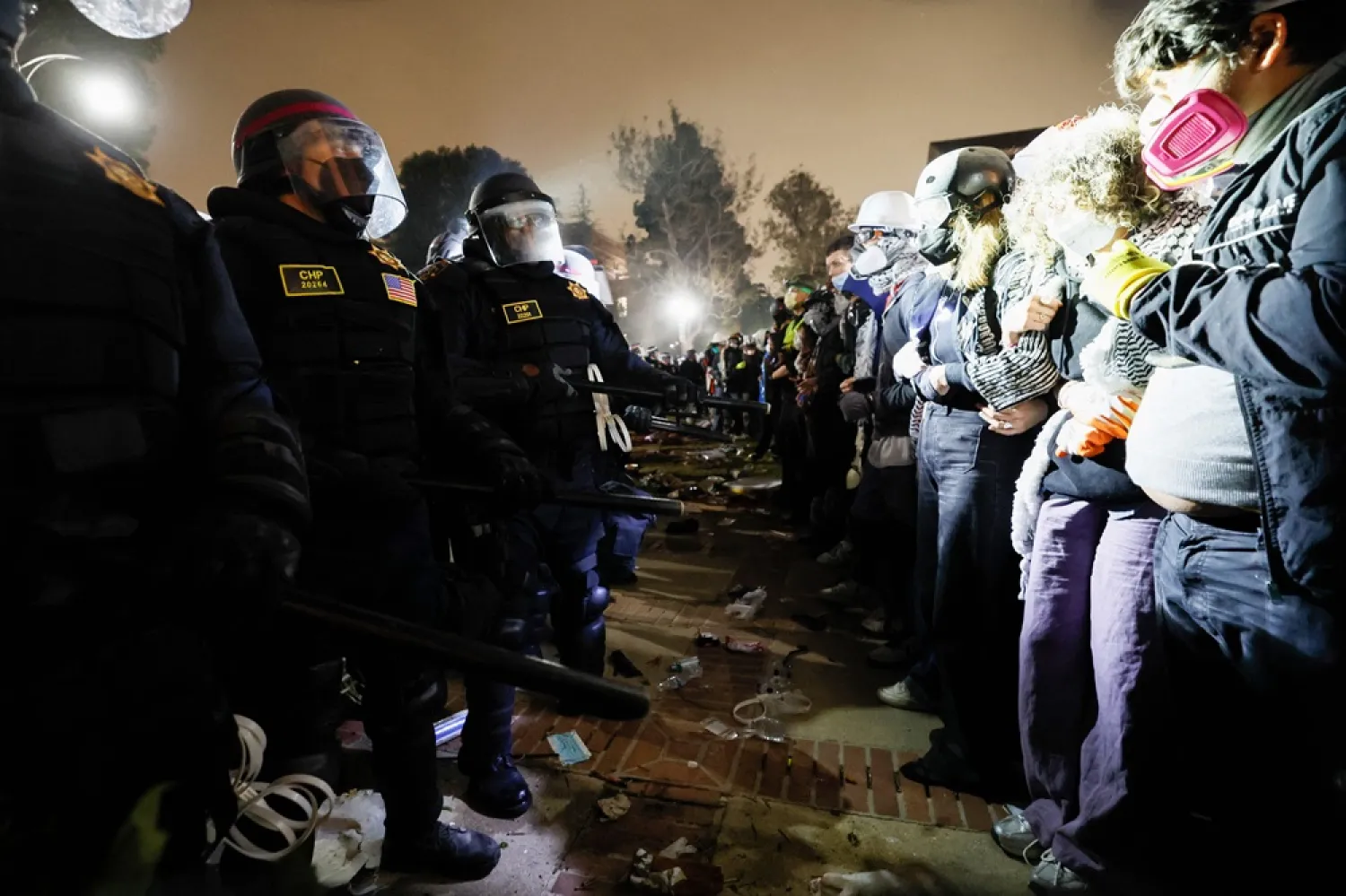 Police face-off with pro-Palestinian students after destroying part of the encampment barricade on the campus of the University of California, Los Angeles (UCLA) in Los Angeles, California, early on May 2, 2024. (AFP) 