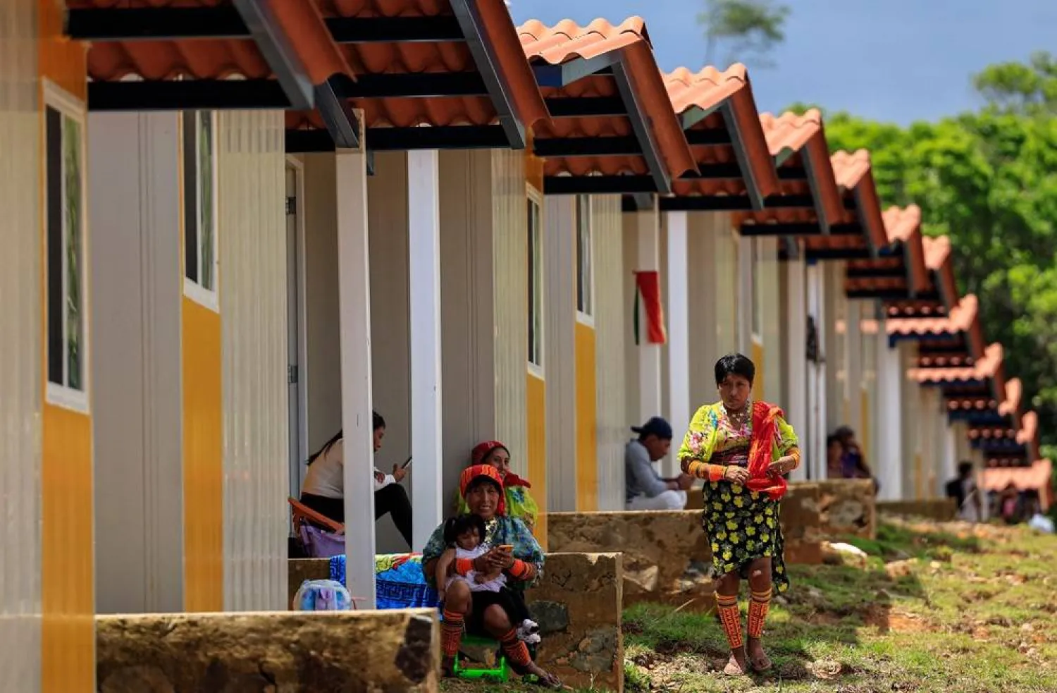 Indigenous Gunas sit outside their new homes in Nuevo Carti, Guna Yala Comarca, on the Caribbean coast in mainland Panama, on May 29, 2024. (AFP)