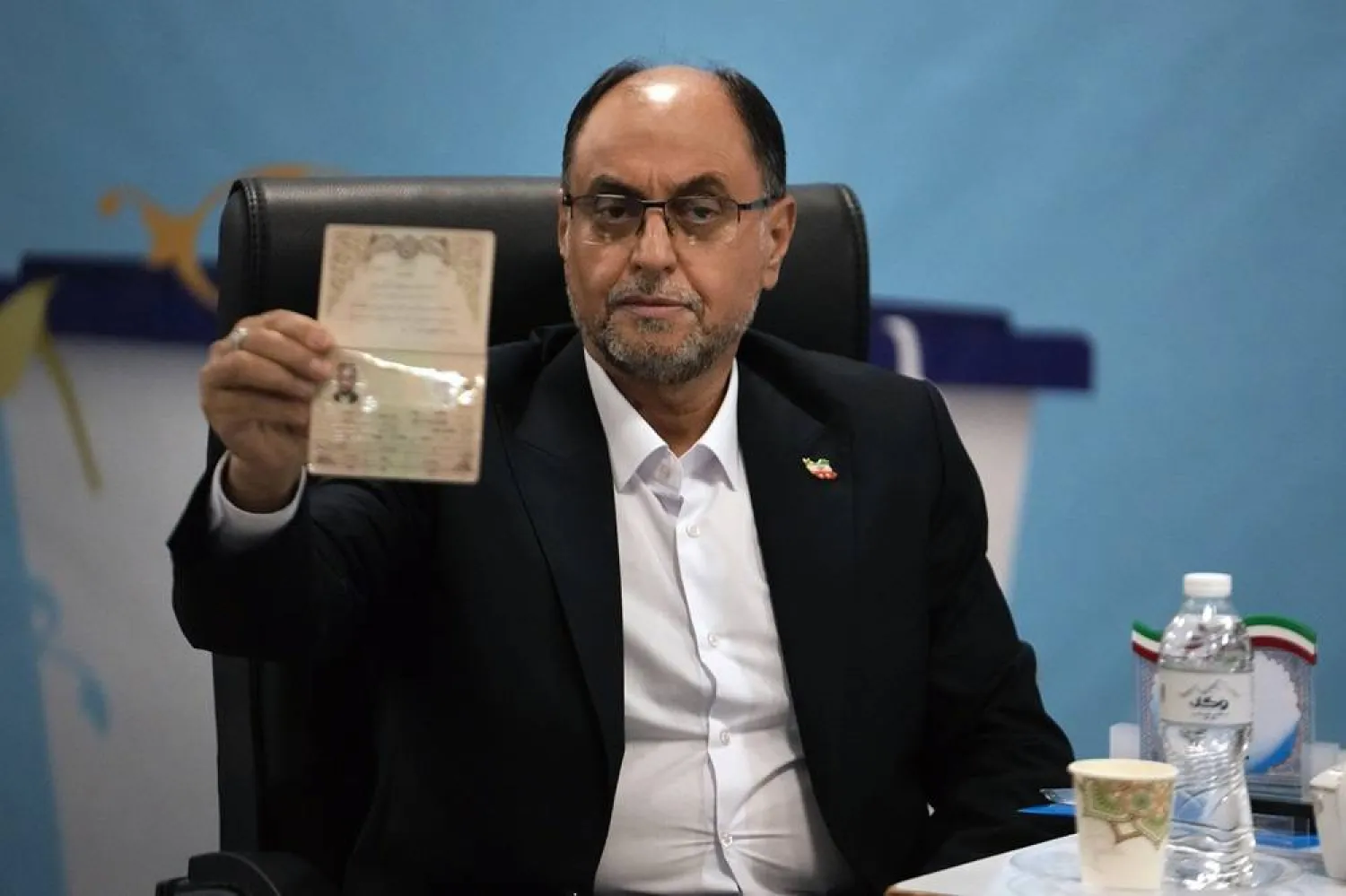 Vahid Haghanian, a longstanding senior official of the Iranian Supreme Leader's office, shows his identification document to the media while registering his name as a candidate for the June 28 presidential election at the Interior Ministry, in Tehran, Iran, Saturday, June 1, 2024. (AP)