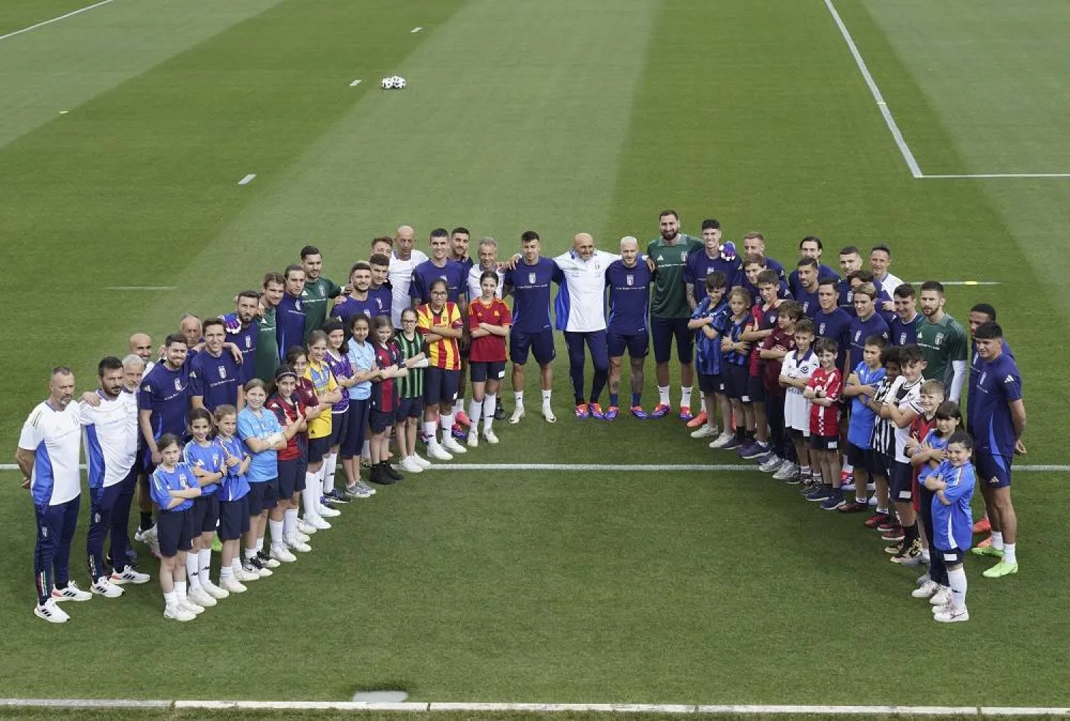 Italy coach Luciano Spalletti poses with players as he leads a training session of the Italian national soccer team in Coverciano, near Florence, Italy, Friday, May 31, 2024. (Marco Bucco/LaPresse via AP)