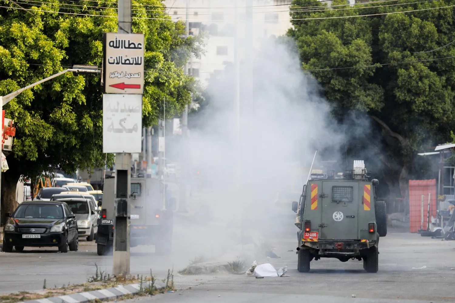 Smoke billows next to military vehicles during an Israeli raid in Balata camp, in Nablus, the Israeli-occupied West Bank, June 3, 2024. REUTERS/Raneen Sawafta