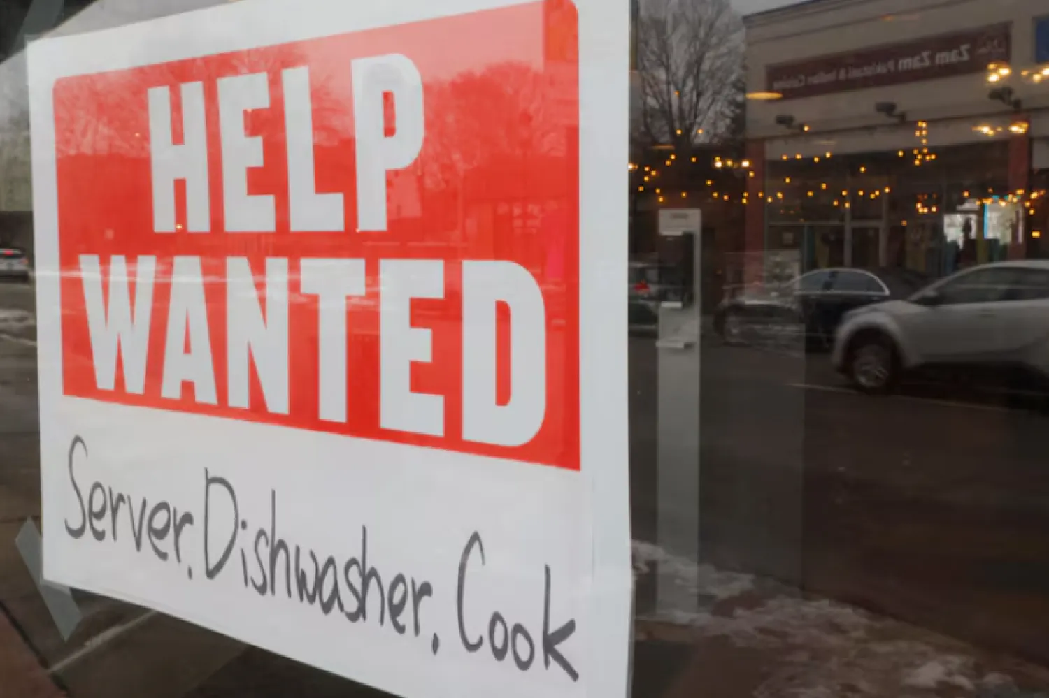 A “Help Wanted” sign hangs in restaurant window in Medford, Massachusetts, US, January 25, 2023. REUTERS/Brian Snyder/File Photo Purchase Licensing Rights