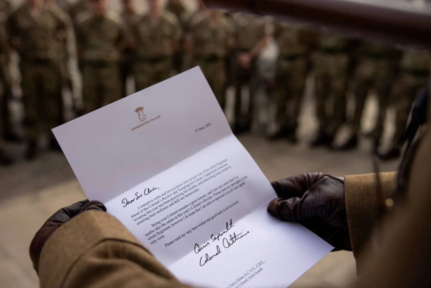 A person holds a letter from Britain's Catherine, Princess of Wales, to the Irish Guards, at an unknown location, in this handout image released June 8, 2024. Irish Guards via X/Handout via REUTERS