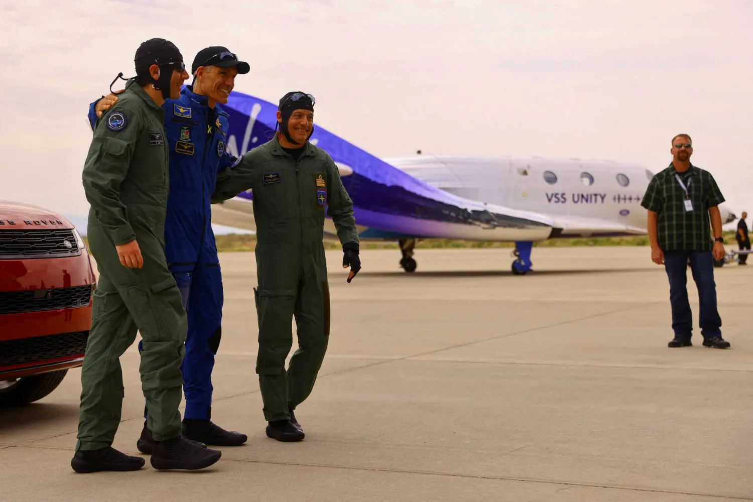 FILE PHOTO: Crew members from Italy hug each other after their return from Virgin Galactic's rocket plane first commercial flight to the edge of space, at the Spaceport America facility, in Truth or Consequences, New Mexico, US, June 29, 2023. REUTERS/Jose Luis Gonzalez/File Photo