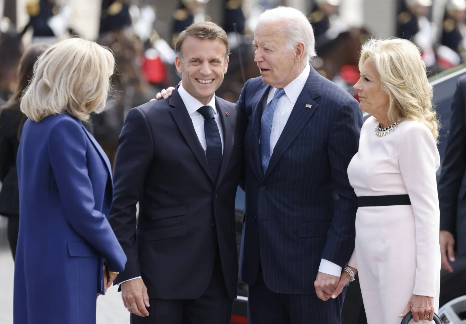 French President Emmanuel Macron, second left, his wife Brigitte Macron, left, welcome President Joe Biden and First Lady Jill Biden before a ceremony at the Arc de Triomphe, Saturday June 8, 2024 in Paris. (Ludovic Marin, Pool via AP)
