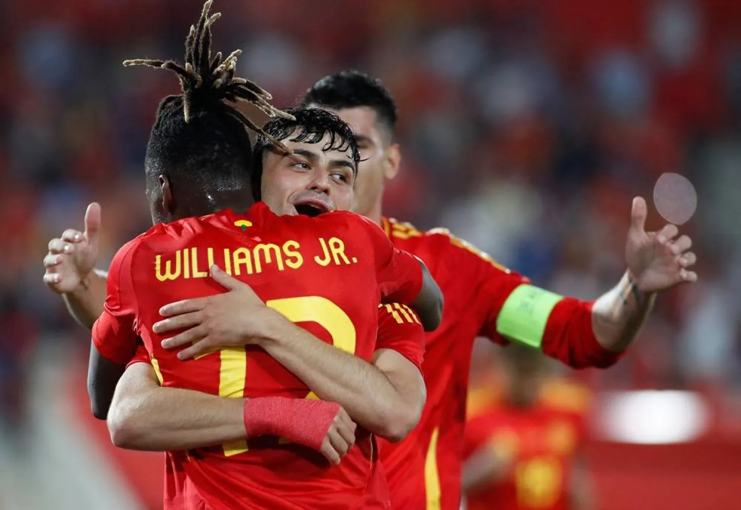 Spain’s midfielder #20 Pedri celebrates with Spain's forward #12 Nico Williams after scoring his team's third goal during the international friendly football match between Spain and North Ireland at Son Moix stadium in Palma de Mallorca on June 8, 2024. (AFP)  