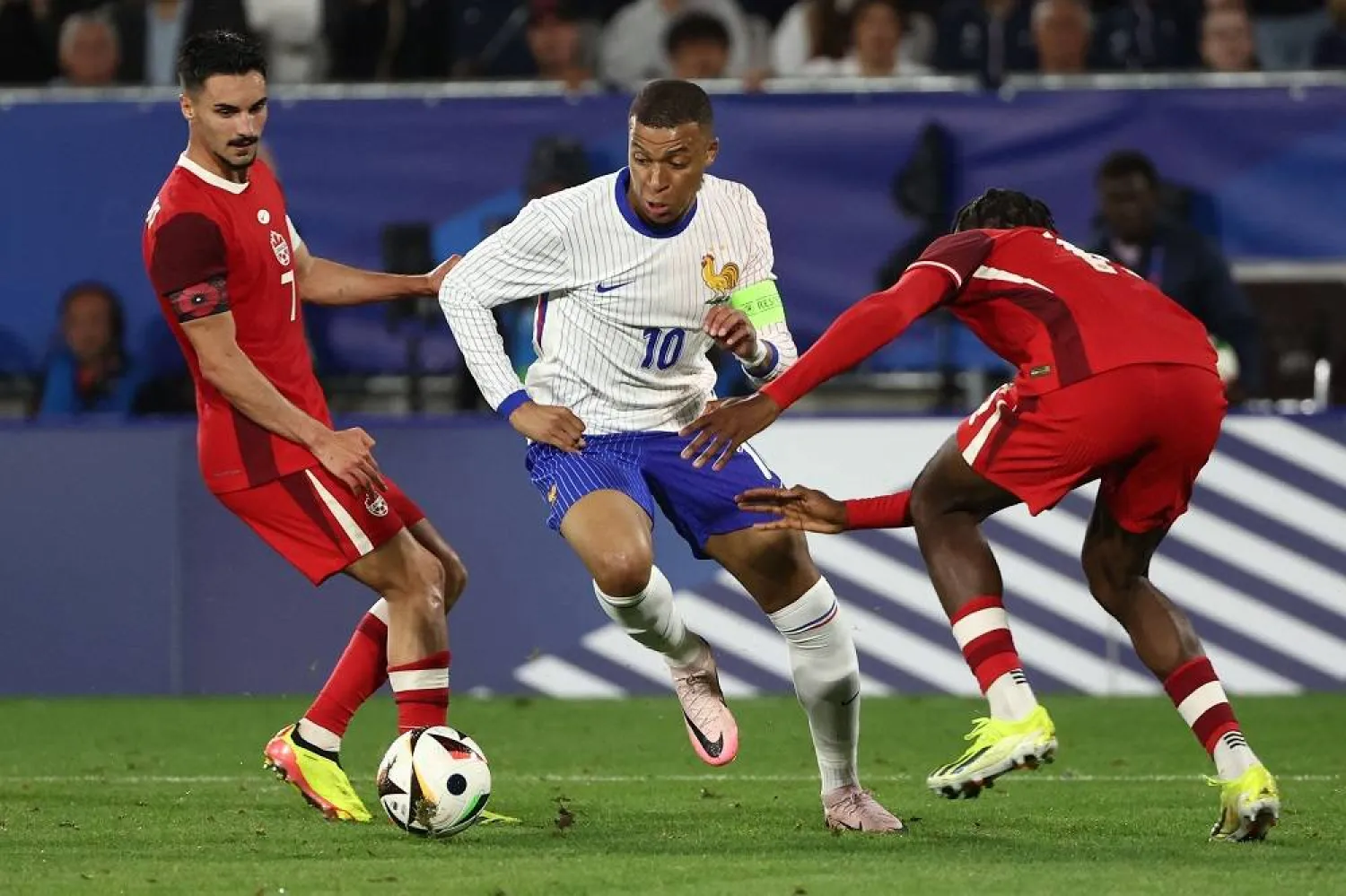 France's forward #10 Kylian Mbappé (C) runs with the ball during the International friendly football match between France and Canada at the Matmut Atlantique stadium in Bordeaux, on June 9, 2024. (AFP)