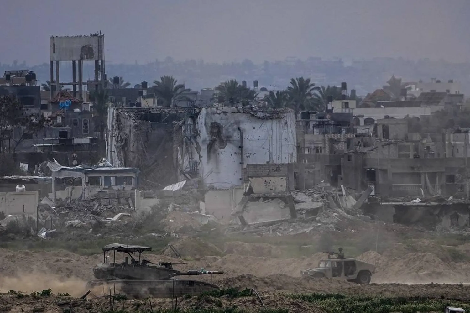 Israeli soldiers operate inside the Gaza Strip, as seen from southern Israel, on Feb. 13, 2024. (AP)