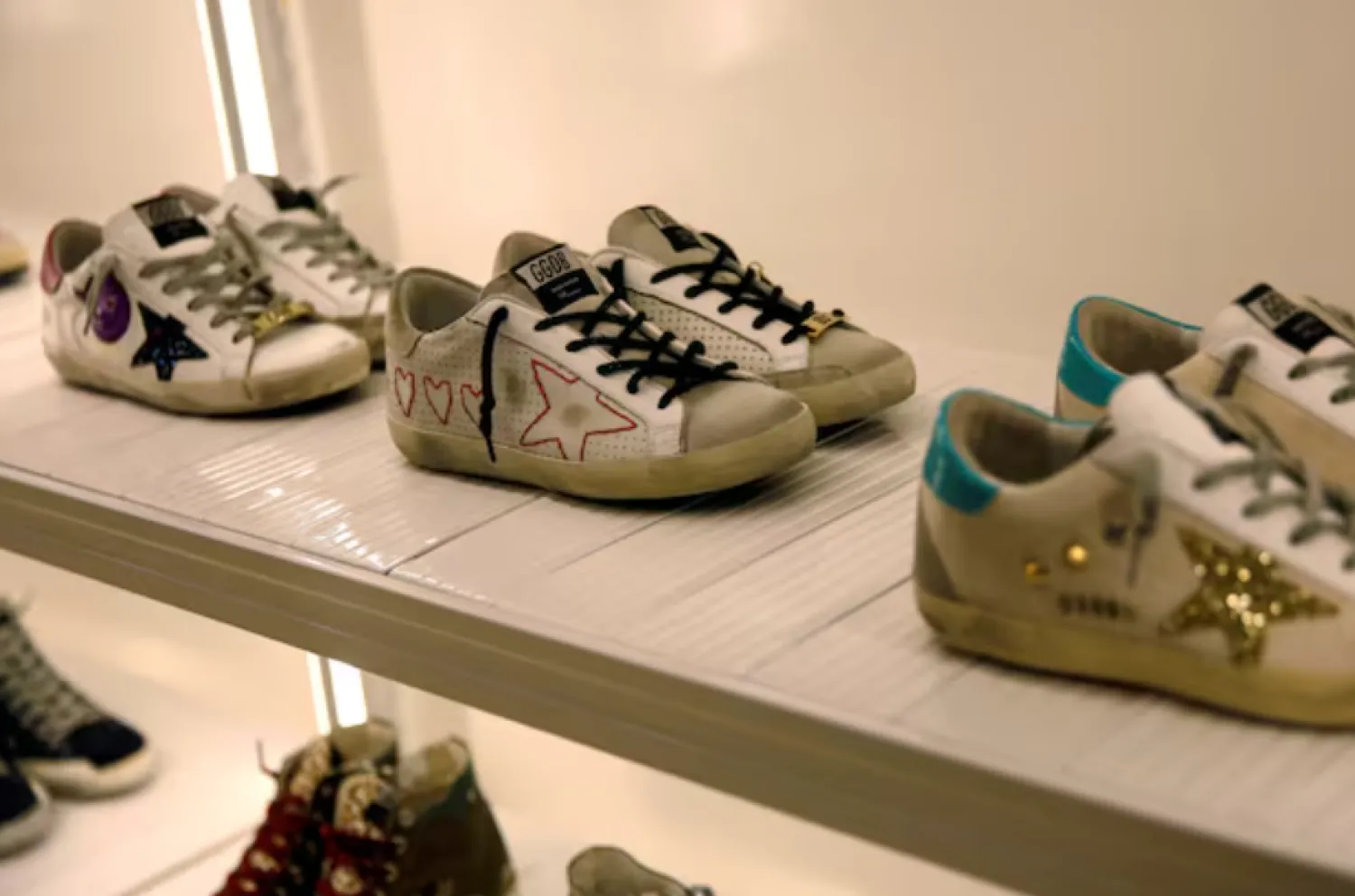 Sneakers of Italian high fashion sneaker brand Golden Goose are displayed at its store in Beijing, China, September 23, 2020. REUTERS/Tingshu Wang/File Photo Purchase Licensing Rights