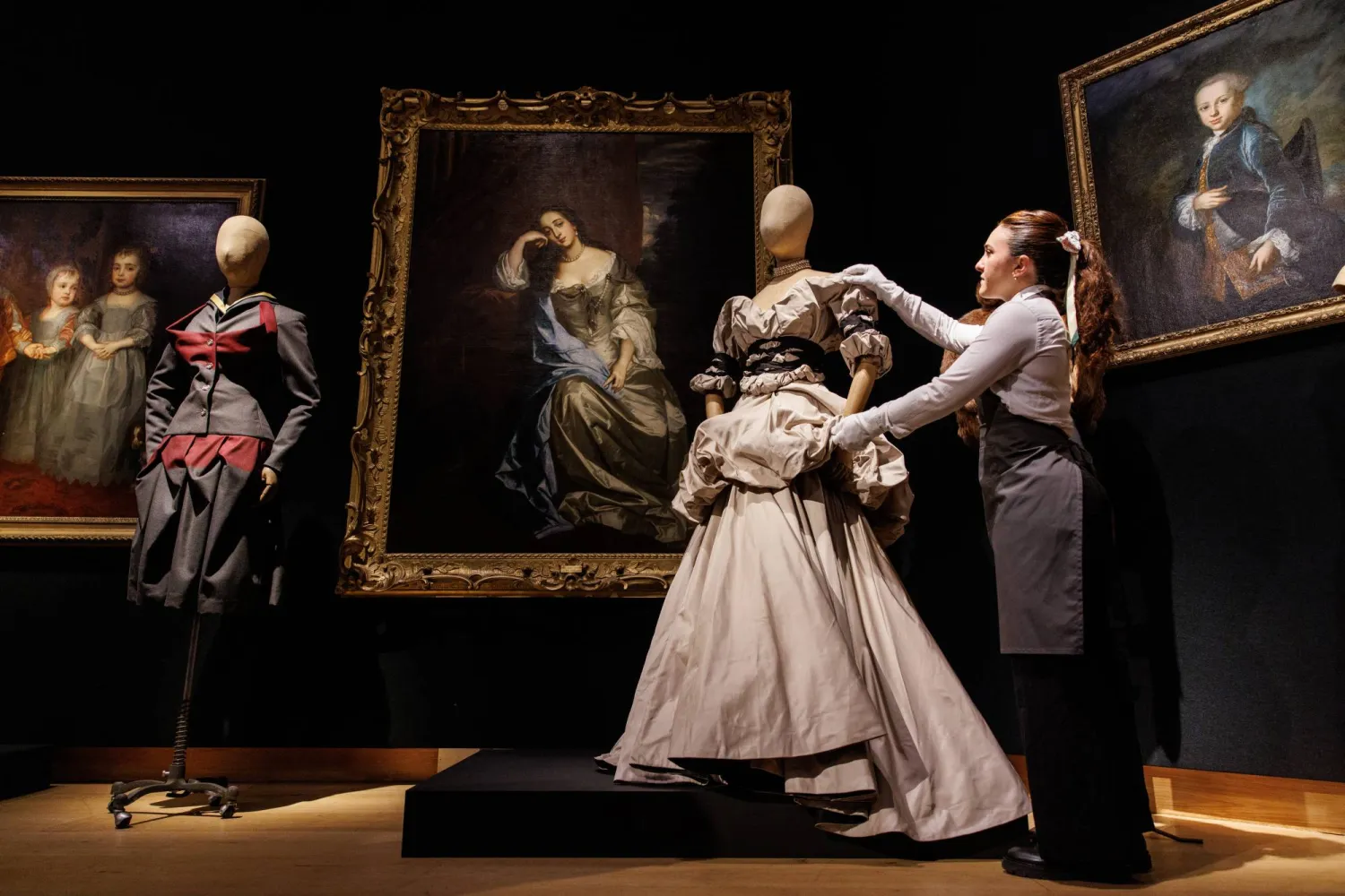 Gallery staff pose with a dress from the 'DRESSED TO SCALE' collection by late British fashion designer Vivienne Westwood (1941-2022) during a press view at Christie's auction house in London, Britain, 13 June 2024. EPA/TOLGA AKMEN