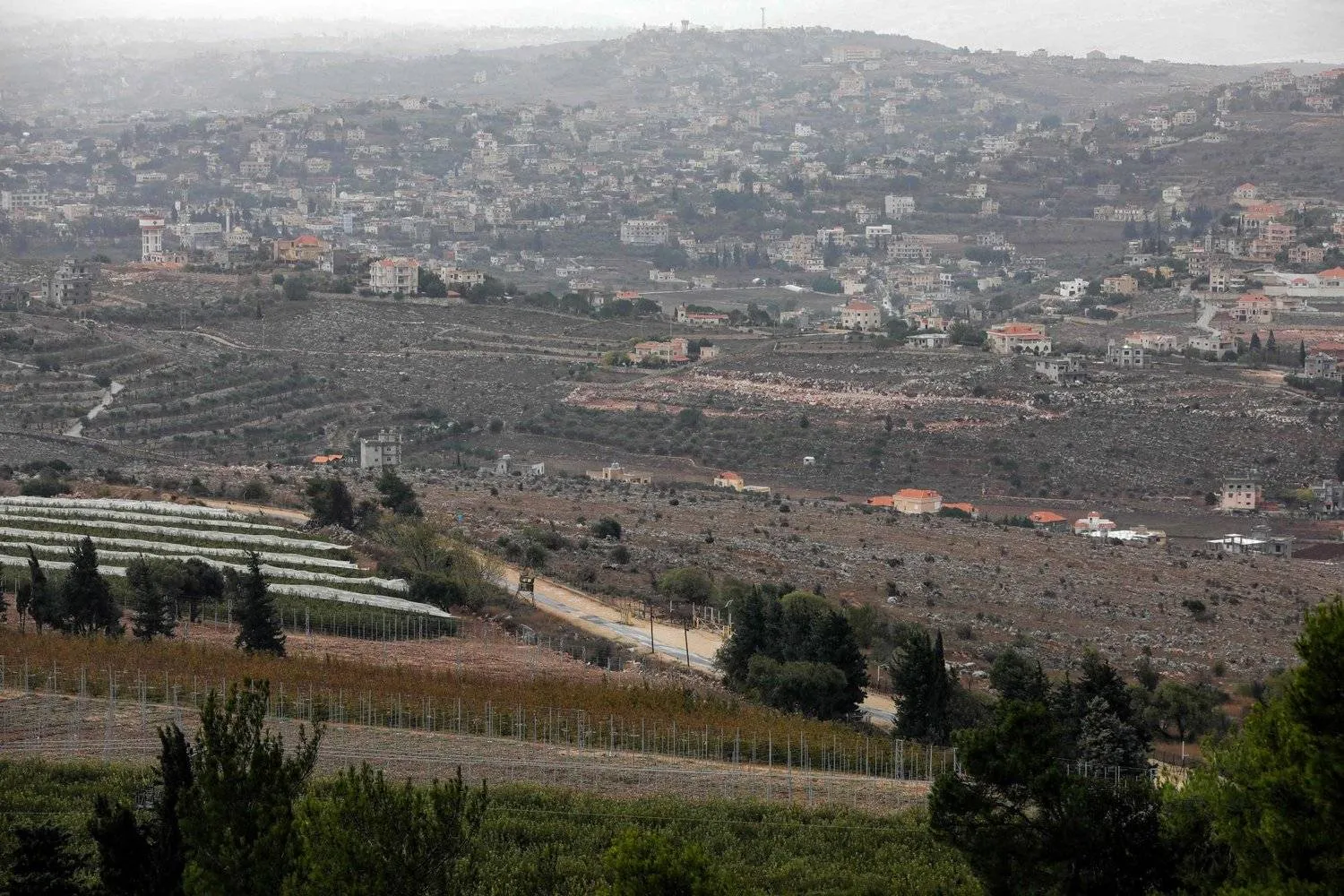 This picture taken from Kibbutz Manara in northern Israel on November 27, 2023, shows the southern Lebanon village of Hula. (Photo by jalaa marey / AFP)
