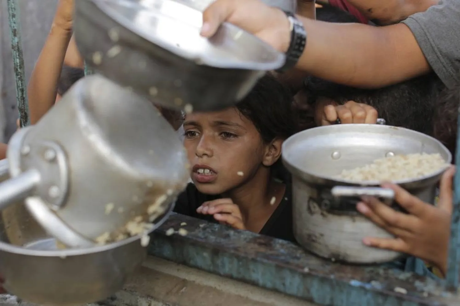  A Palestinian boy watches his portion of food aid ahead of the upcoming Eid al-Adha holiday in Khan Younis, Saturday, June 15, 2024. (AP)