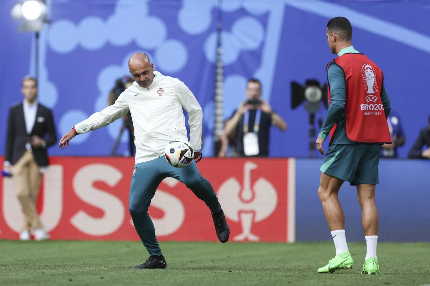 مدرب البرتغال مارتينيز يحاول السيطرة على الكرة وسط متابعة رونالدو (إ.ب.أ)