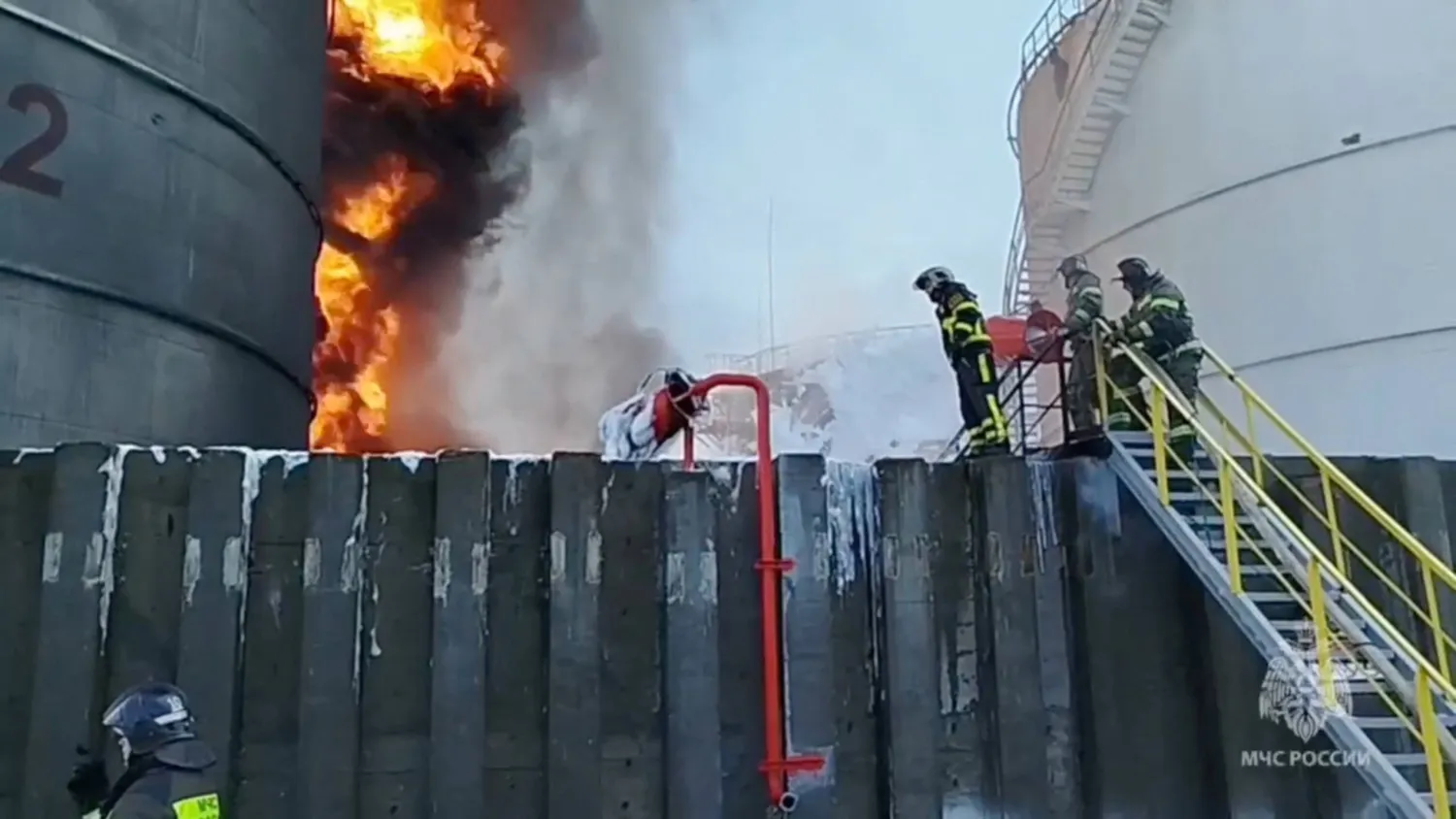 Members of the Russian emergencies ministry work to extinguish fire at an oil storage tank after an alleged drone attack in the town of Azov in the southern region of Rostov, Russia, June 18, 2024, in this still image taken from video. Russian Emergencies Ministry/Handout via REUTERS
