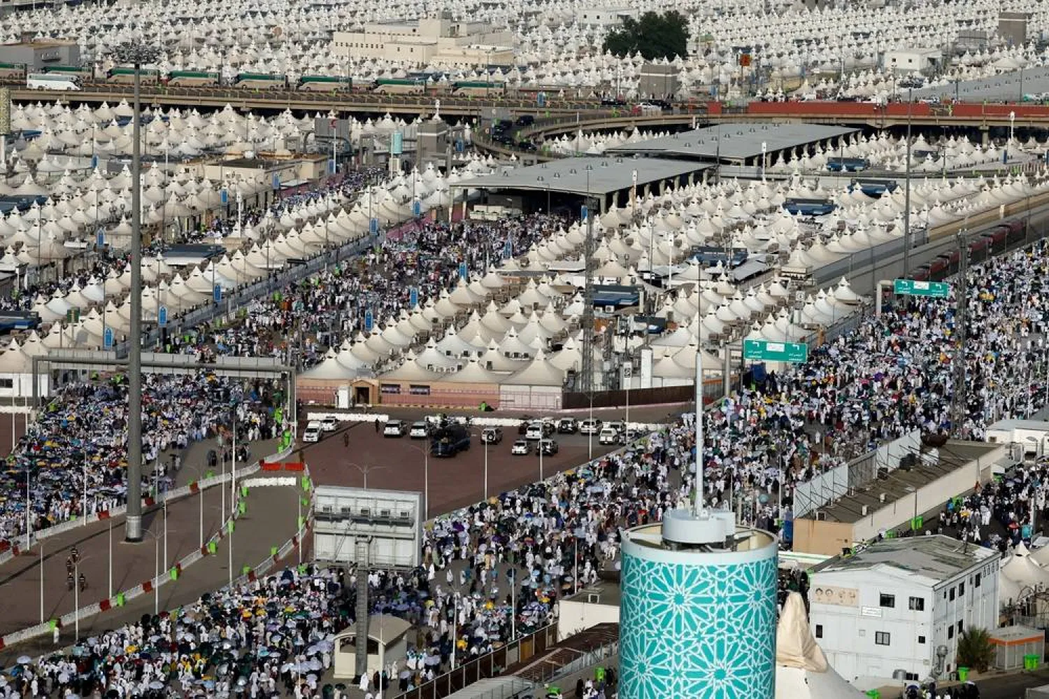 Muslim pilgrims walk on the second day of the devil stoning ritual, during the annual haj pilgrimage, in Mina, Saudi Arabia, June 17, 2024. (Reuters)