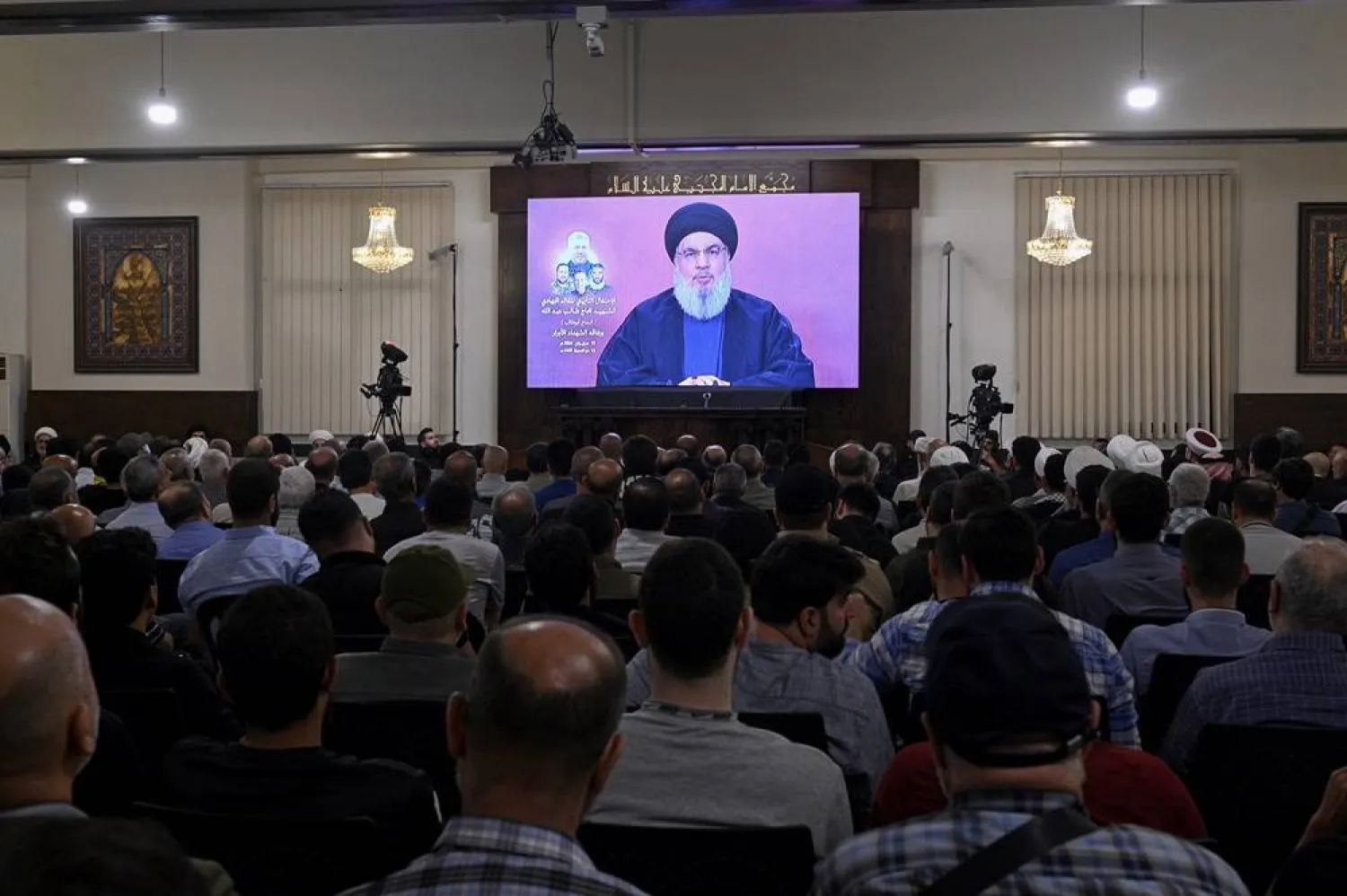 Hezbollah leader Hassan Nasrallah delivers a speech via a screen at a memorial ceremony for senior Field Commander, Taleb Sami Abdallah, known within Hezbollah as Hajj Abu Taleb who was killed on 11 June, in a suburb outside Beirut, in Beirut, Lebanon, 19 June 2024. (EPA) 