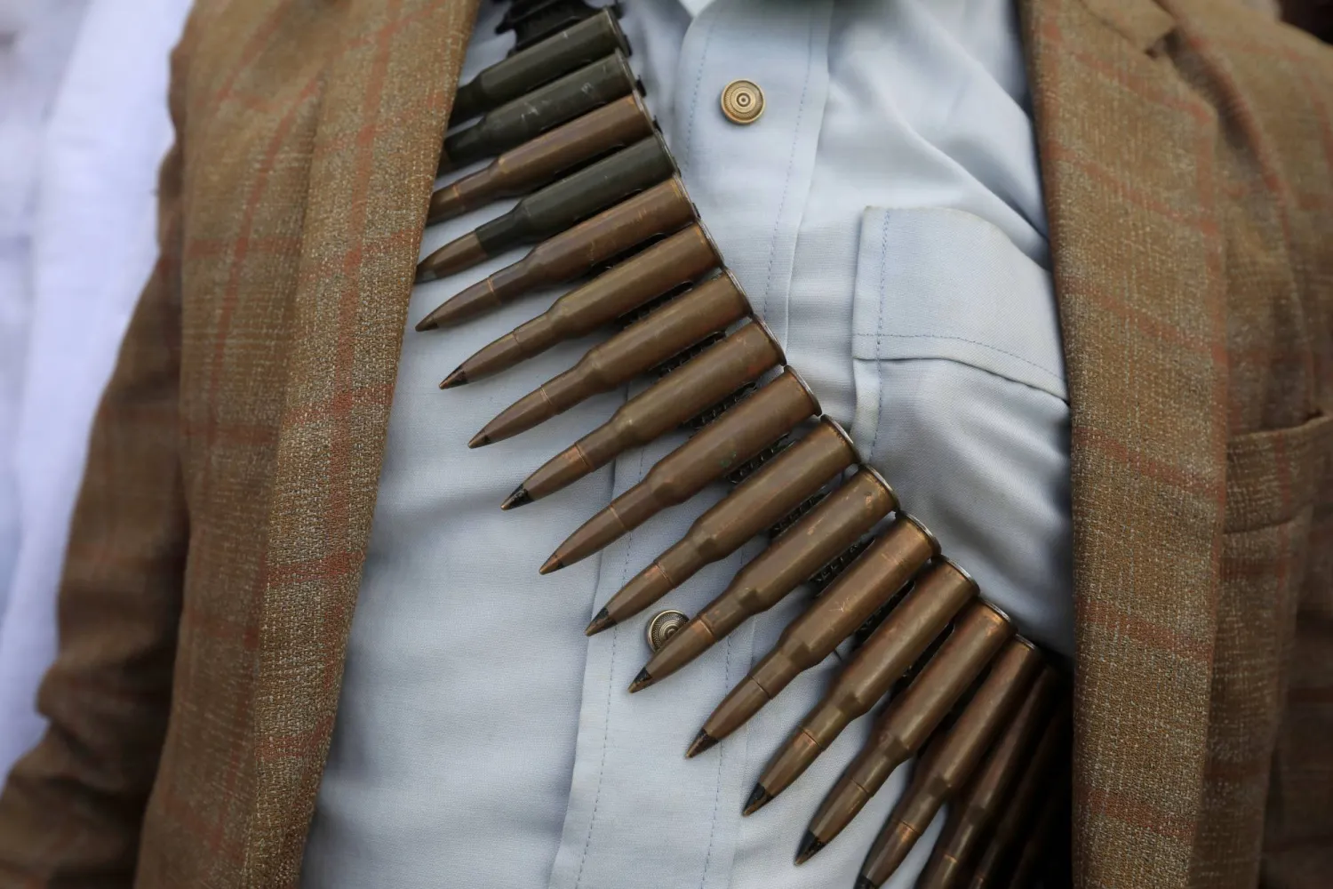 A Houthi supporter wearing a gun bullet belt around his chest takes part in a protest against the US and Israel, and in solidarity with the Palestinian people, in Sanaa, Yemen, 14 June 2024. EPA/YAHYA ARHAB