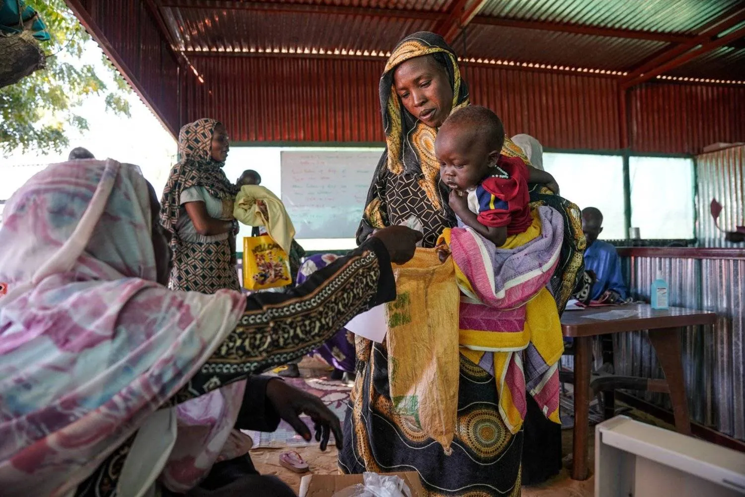 FILE PHOTO: A handout photograph, shot in January 2024, shows a woman and baby at the Zamzam displacement camp, close to El Fasher in North Darfur, Sudan. MSF/Mohamed Zakaria/Handout via REUTERS