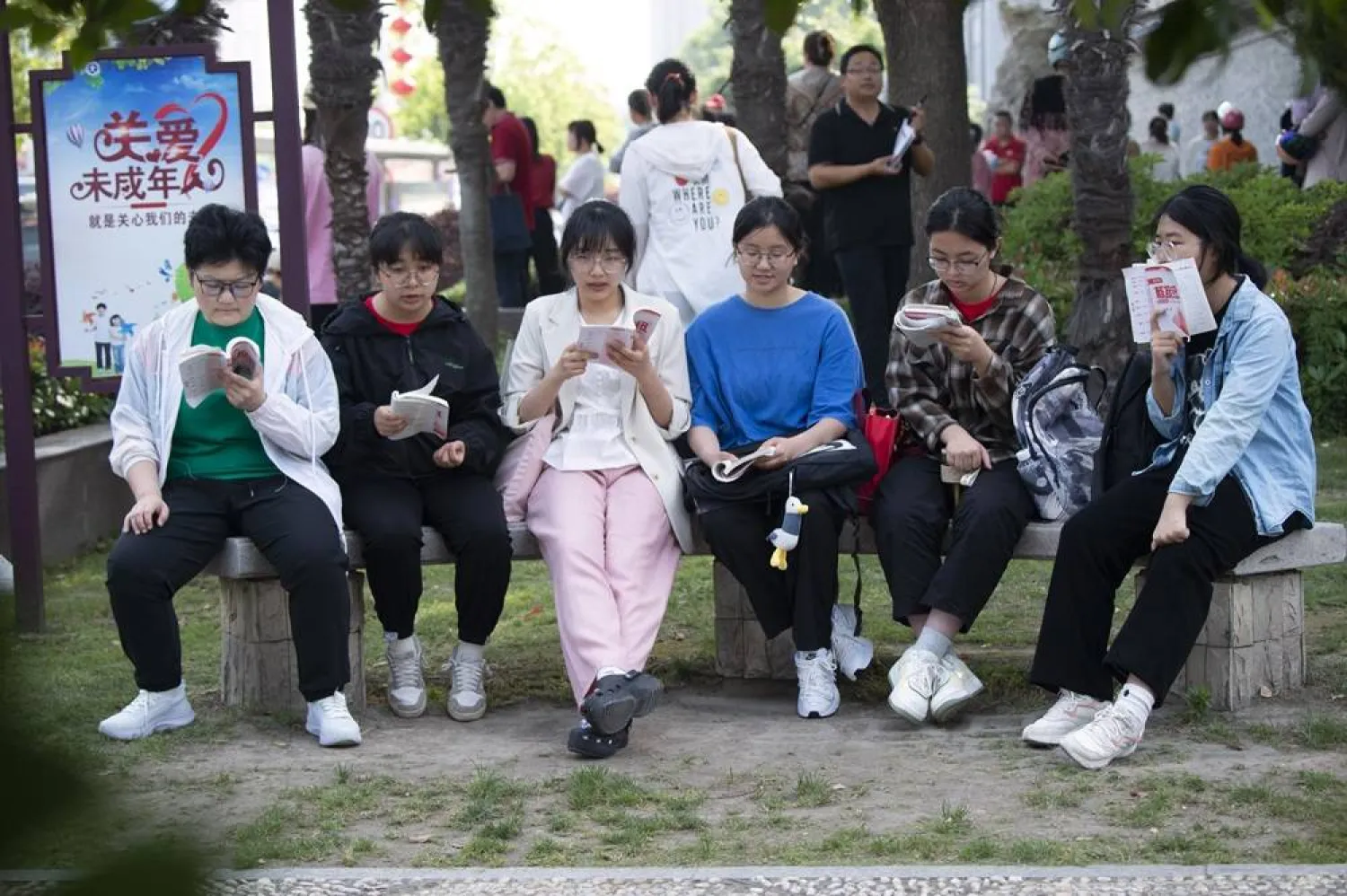 Students review their exam preparation materials in the last minutes before the National College Entrance Exam, or Gaokao, outside an exam venue in Hai'an city in east China's Jiangsu province Friday, June 7, 2024. (Chinatopix via AP) 