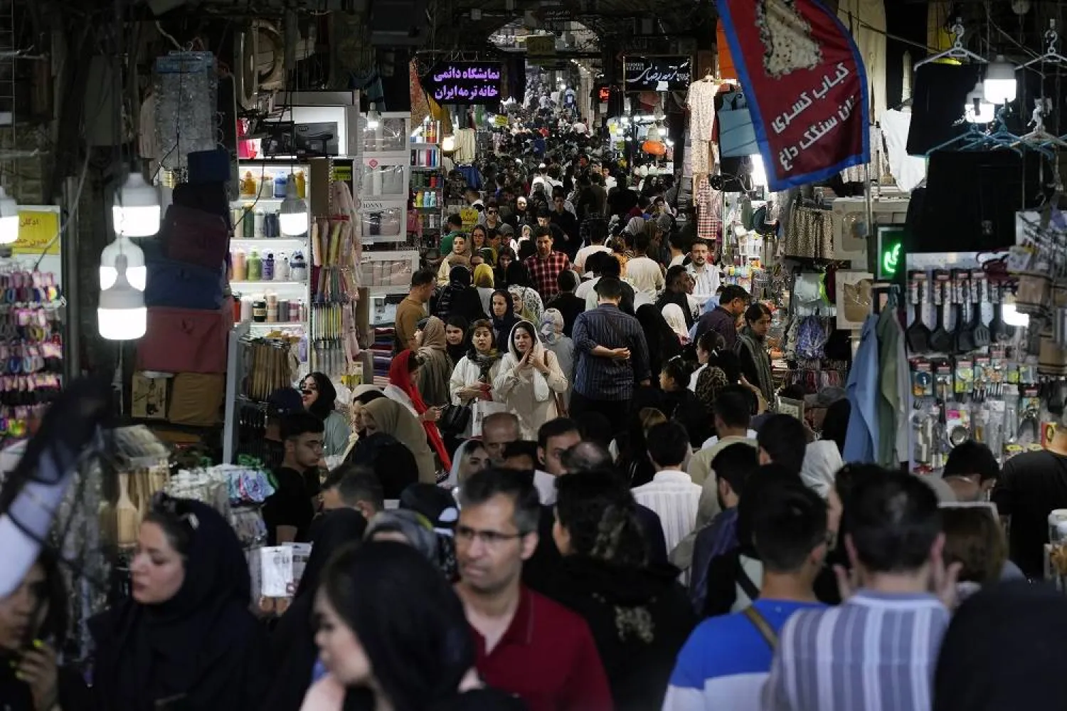 People walk through the old main bazaar of Tehran, Iran, Thursday, June 13, 2024. (AP)