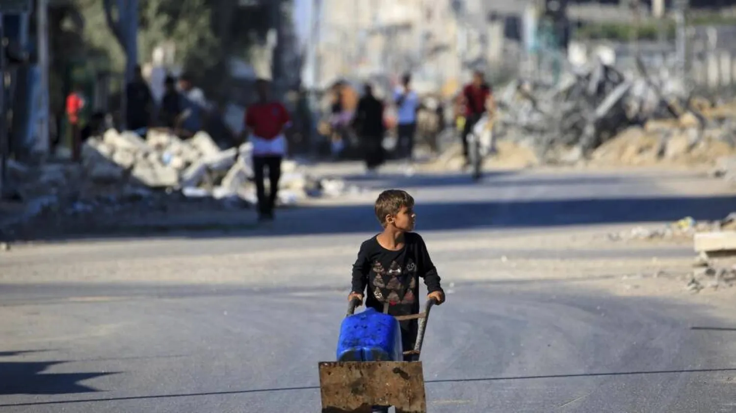 A boy carries water in al-Bureij refugee camp in Gaza, where UN agencies have warned of dire shortages of vital supplies. Eyad BABA / AFP