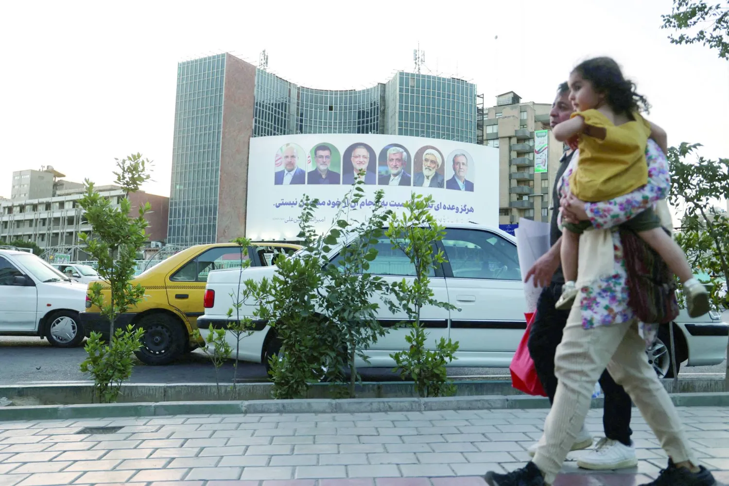 A billboard with a picture of the presidential candidates is displayed on a street in Tehran, Iran, June 17, 2024. Majid Asgaripour/WANA (West Asia News Agency) via REUTER/File Photo