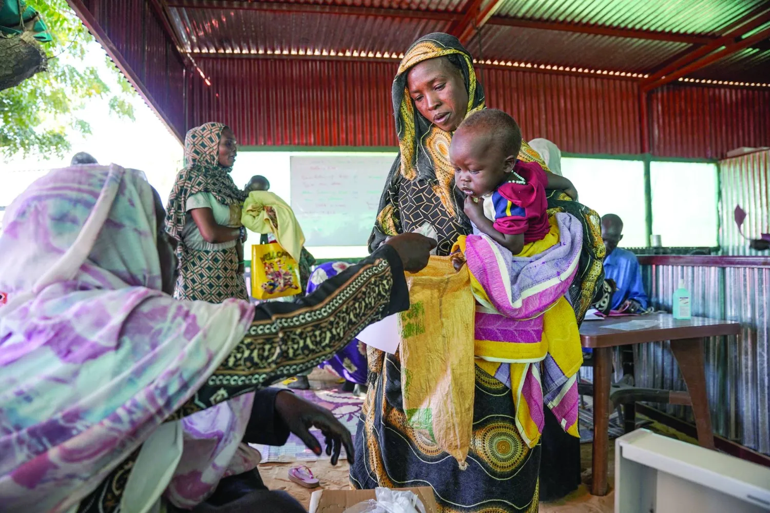 FILE PHOTO: A handout photograph, shot in January 2024, shows a woman and baby at the Zamzam displacement camp, close to El Fasher in North Darfur, Sudan. MSF/Mohamed Zakaria/Handout via REUTERS/Files