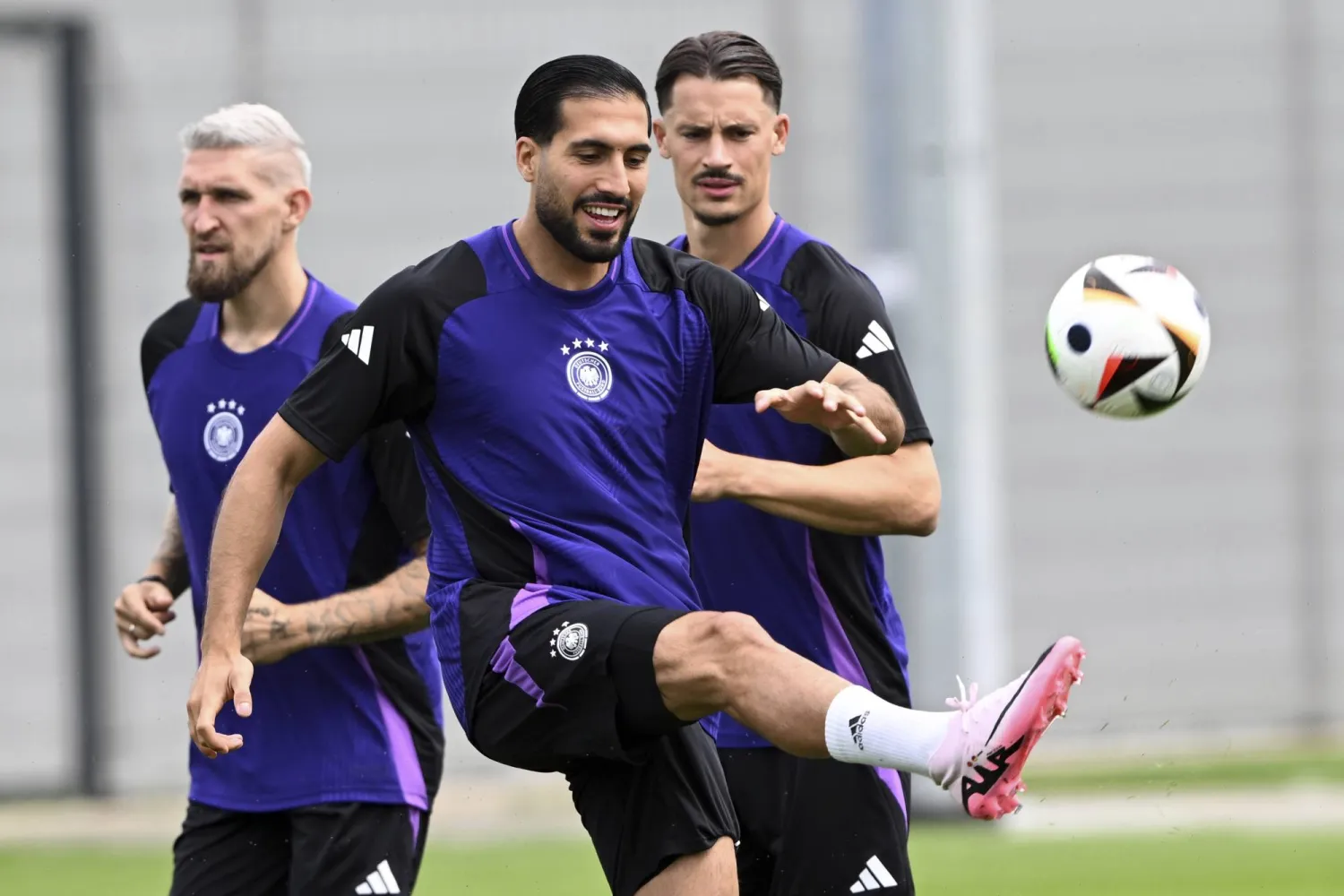 From left, Germany's Robert Andrich, Emre Can and Robin Koch practice during the team training session in Herzogenaurach, Germany, Friday June 28, 2024. (Federico Gambarini/dpa via AP)