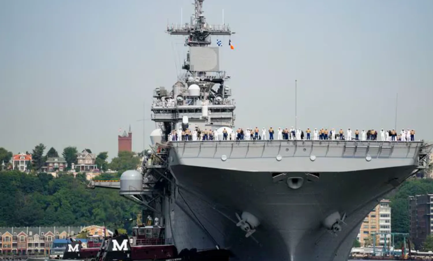 FILE - Sailors and military service personnel arrive on the USS Wasp amphibious assault ship on the Hudson River during fleet week, May 24, 2023, in New York. (AP Photo/John Minchillo, FIle)

