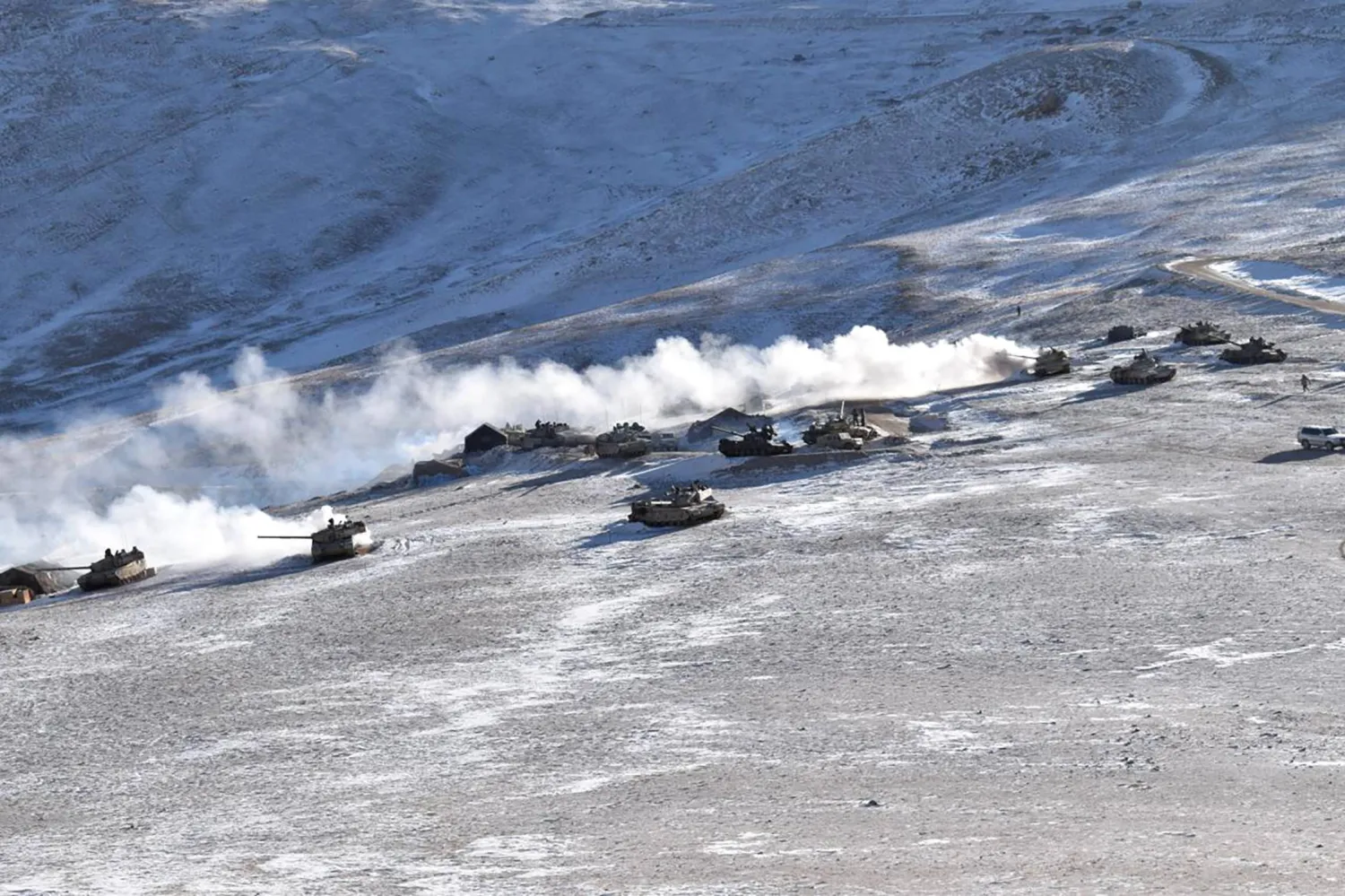 FILE - In this file photo provided by the Indian Army, tanks pull back from the banks of Pangong Tso lake region, in Ladakh along the India-China border on Feb. 10, 2021. (Indian Army via AP, File)