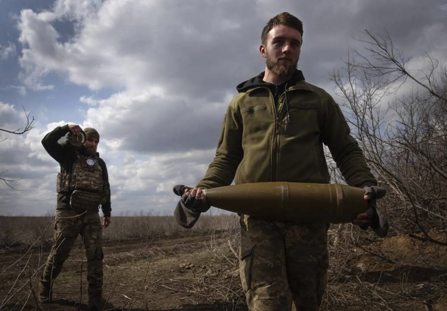 Ukrainian soldiers carry shells to fire at Russian positions on the front line, near the city of Bakhmut, in Ukraine's Donetsk region, on March 25, 2024. (AP)