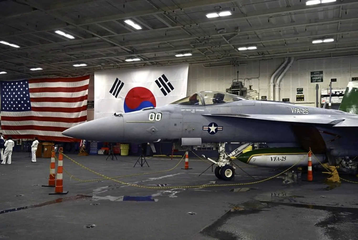An F-18 fighter aircraft sits in the hanger of the Theodore Roosevelt (CVN 71), a nuclear-powered aircraft carrier, anchored in Busan Naval Base in Busan, South Korea Saturday, June 22, 2024. (Song Kyung-Seok/Pool Photo via AP, File) 