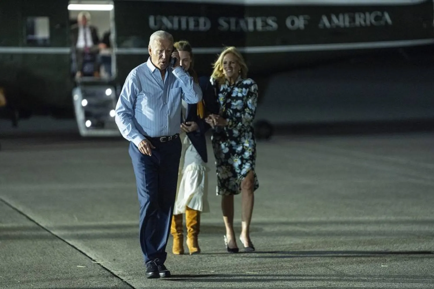  President Joe Biden, left, talks on the phone as he walks to board Air Force One at McGuire Air Force Base, Saturday, June 29, 2024, in Burlington County, N.J. (AP)