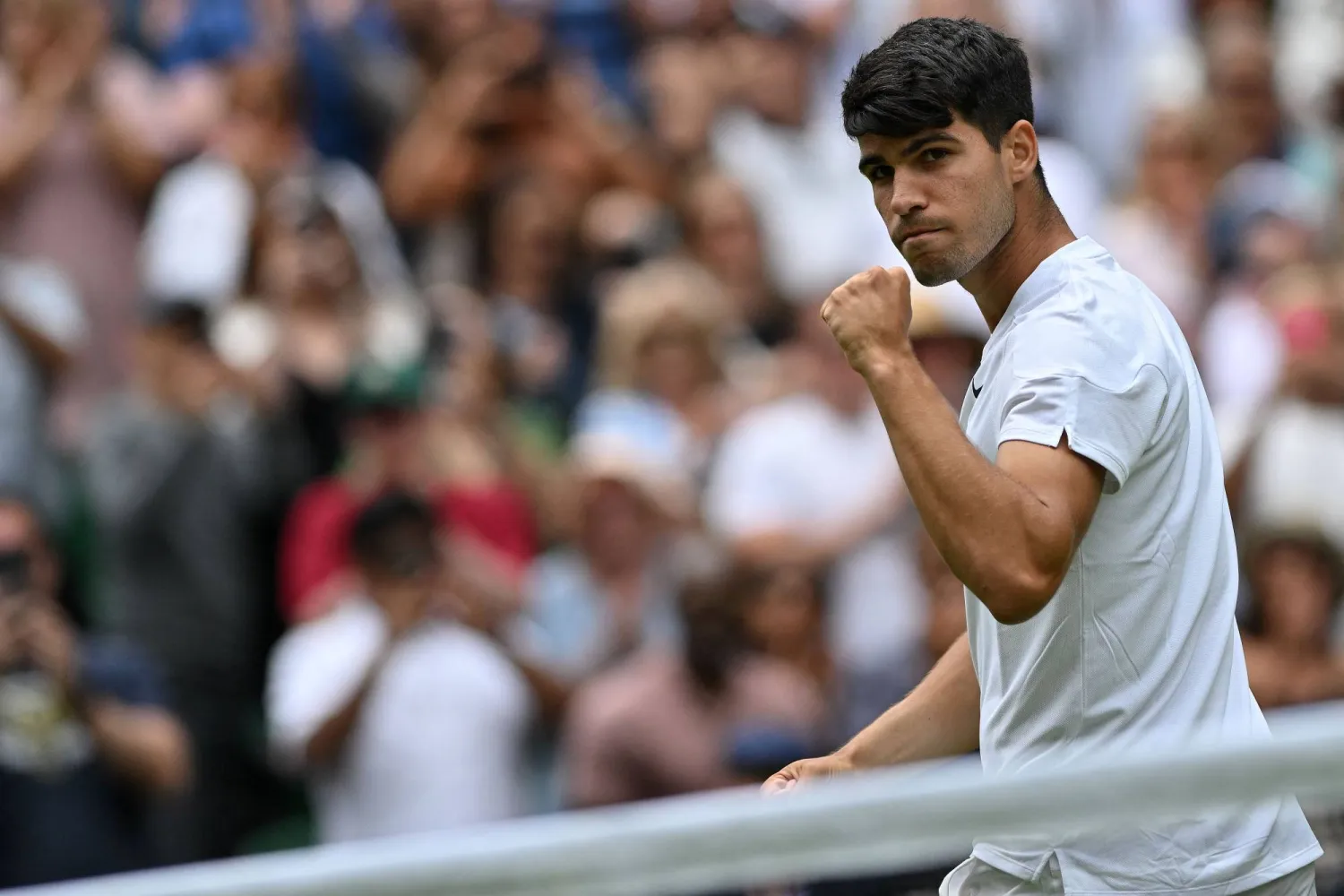 Spain's Carlos Alcaraz celebrates winning against Estonia's Mark Lajal during their men's singles tennis match on the first day of the 2024 Wimbledon Championships at The All England Lawn Tennis and Croquet Club in Wimbledon, southwest London, on July 1, 2024. (Photo by Glyn KIRK / AFP) 