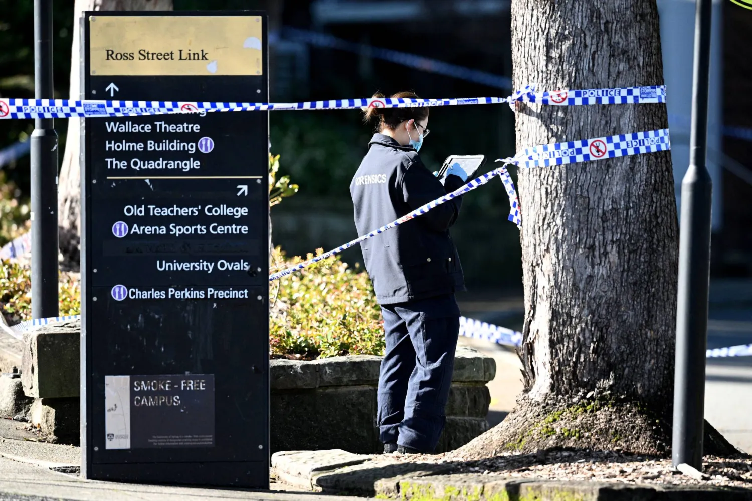 A member of the New South Wales (NSW) law enforcement team works at the scene of an alleged stabbing at the University of Sydney, in Sydney, Australia July 2, 2024.   AAP/Dan Himbrechts via REUTERS    