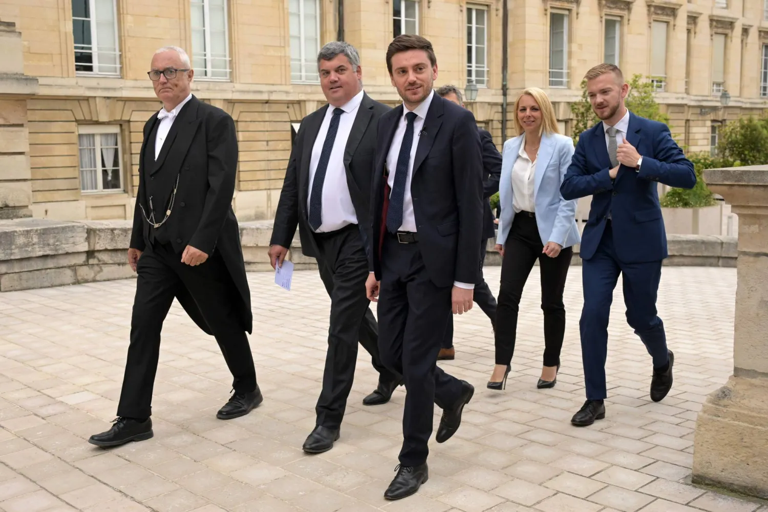 French newly-elected MPs for the far-right Rassemblement National (RN) political party Emeric Salmon (2-R), Alexandre Loubet (C), Edwige Diaz (2-R) and Kevin Pfeffer (R) arrive for a welcoming day at the National Assembly in Paris, on July 2, 2024. (Photo by Bertrand GUAY / AFP)