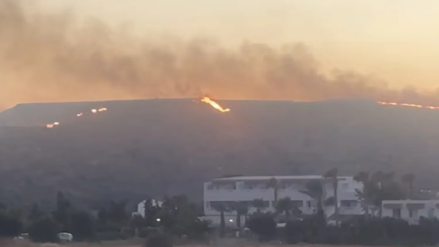 A view of fire around the island of Kos, Greece, July 1, 2024, in this screen grab obtained from a social media video. ALAN BOYLE/via REUTERS Purchase Licensing Rights