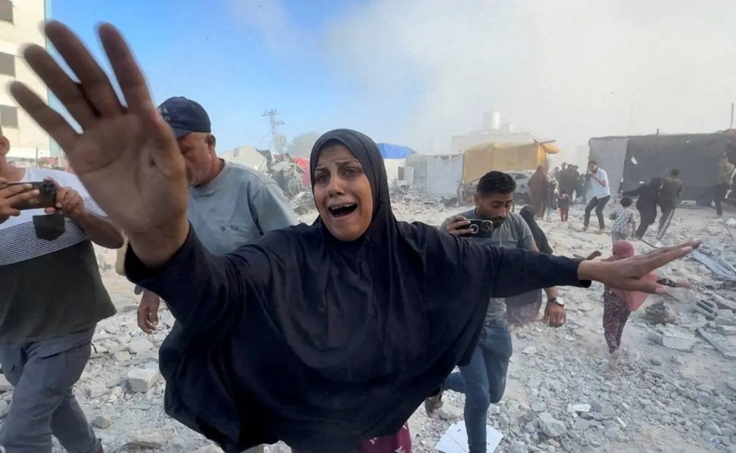  Palestinians react, following an Israeli strike near a UN-run school sheltering displaced people, amid the Israel-Hamas conflict, in Khan Younis, in the southern Gaza Strip, in this still image taken from a video, July 3, 2024. (Reuters)