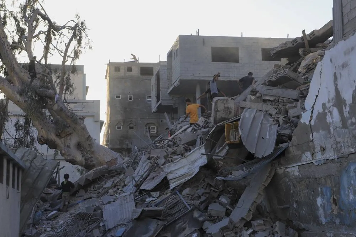  Palestinians search for bodies and survivors in the rubble of a residential building destroyed in an Israeli airstrike in Khan Younis, Gaza Strip, Wednesday, July 3, 2024. (AP)