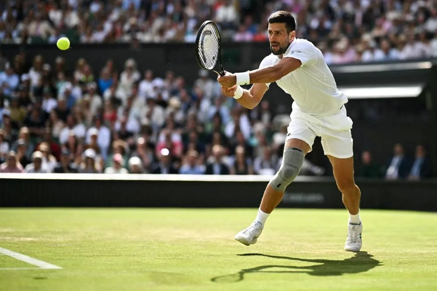  Serbia's Novak Djokovic returns the ball to Britain's Jacob Feamley during their men's singles tennis match on the fourth day of the 2024 Wimbledon Championships at The All England Lawn Tennis and Croquet Club in Wimbledon, southwest London, on July 4, 2024. (AFP)