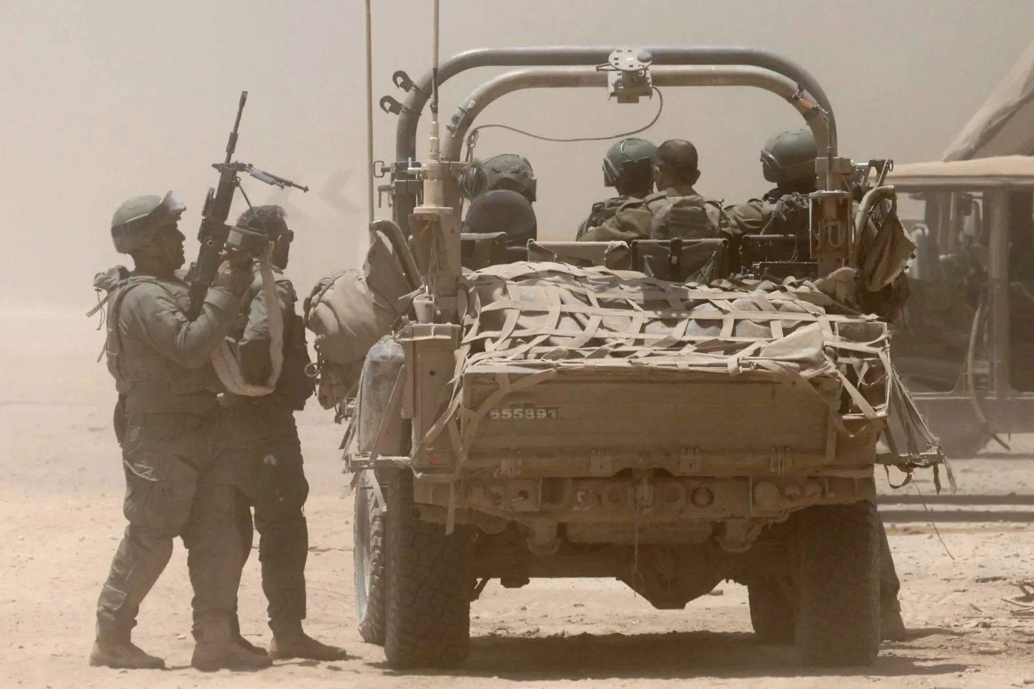 جنود إسرائيليون برفقة مركبة عسكرية في مكان لم يُكشف عنه بالقرب من الحدود مع قطاع غزة جنوب إسرائيل - 2 يوليو 2024 (إ.ب.أ)