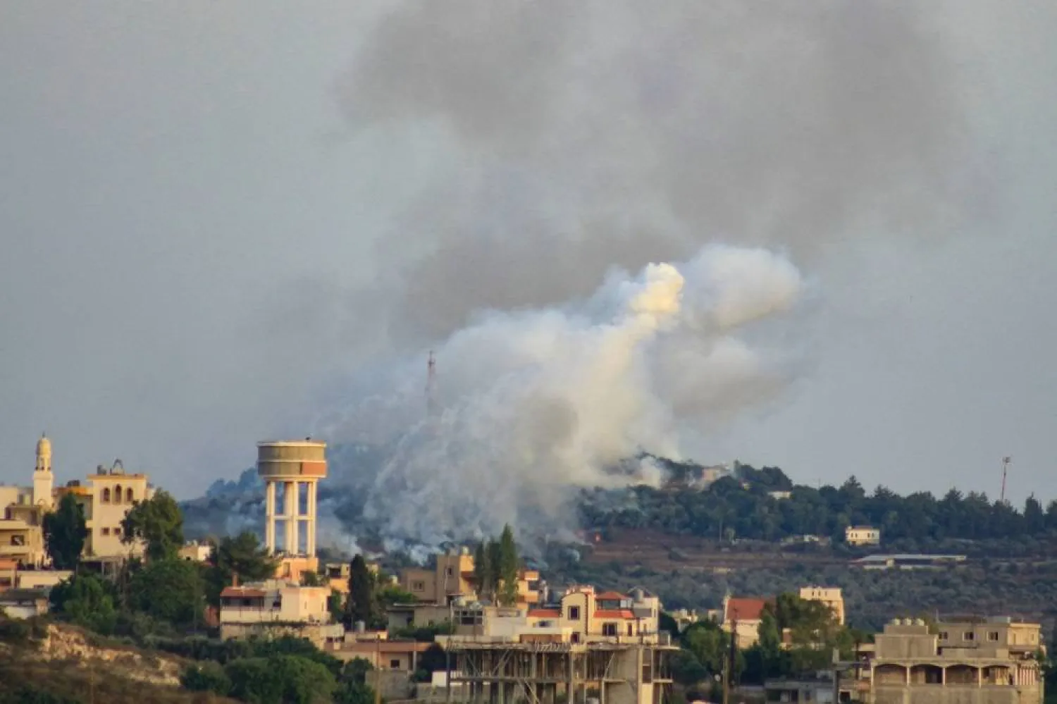Smoke billows from a site targeted by Israeli shelling in the southern Lebanese village of Dhayra on July 4, 2024. (AFP)